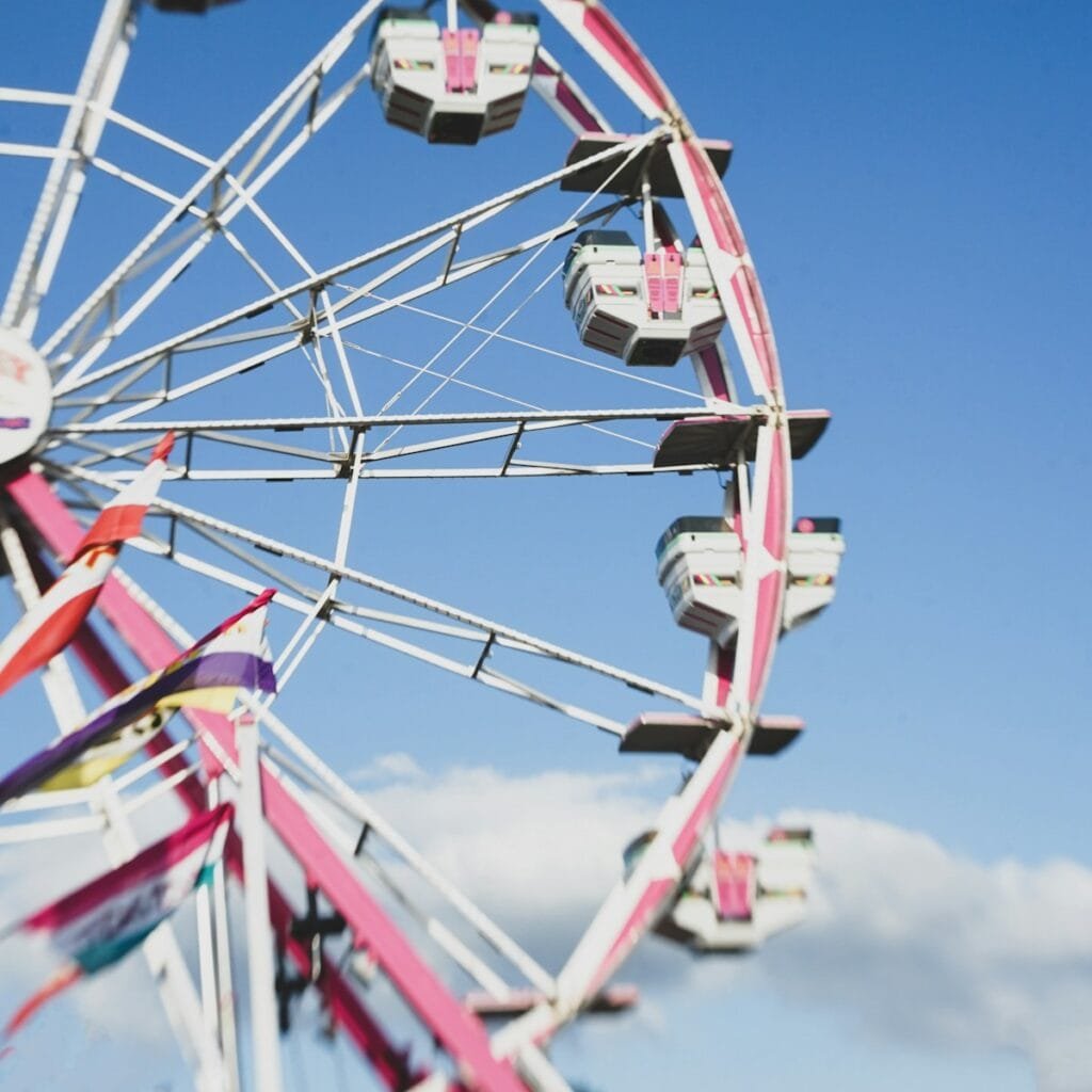 white and red ferris wheel under blue sky during daytime