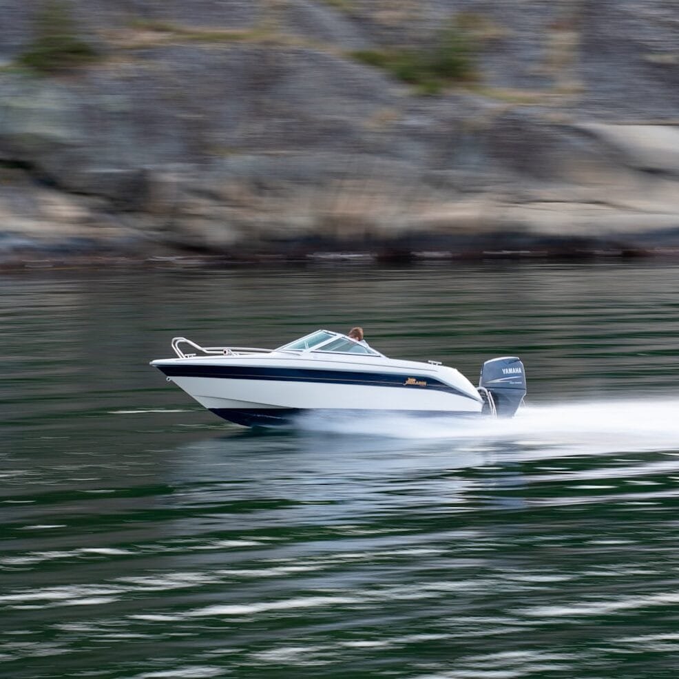 a speed boat speeding across a body of water